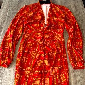 Long sleeve medium sized fitted dress with an opening in the front.